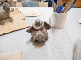 A clay pig wearing a top hat, modelled by a talented individual at Coalport China Museum.
