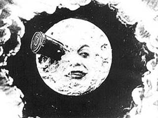 Still frame from Victorian Film showing a rocket sticking out of the literal 'face of the moon'