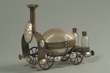 Vanity set in the shape of a steam locomotive, made from 13 nautilus shells mounted on brass.