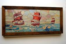 Rectangular tile panel showing 3 stylised galleons at sea, panel is made up of irregular shaped tiles decorated in lustre glazes, ships in red ruby lustre, sea blue and yellow, sky in silver yellow, red and yellow; manufactured by Craven Dunnill and Co., 1914 = 1930.