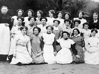 Copy of original postcard showing group portrait of paintresses from Coalport China Works, seated on far left of centre row is Elizabeth Mary Morgan (`Liza') married name Gough