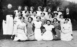 copy of original postcard showing group portrait of paintresses from Coalport China Works, seated on far left of centre row is Elizabeth Mary Morgan (`Liza') married name Gough