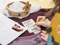 Group of Writing a label for Victorian fancy dress costumes designed for visitors to try on.