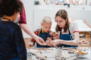 Two children making shapes from clay
